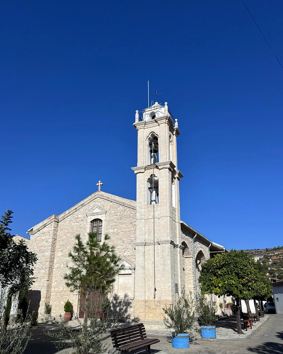Lania village, Cyprus: we walked into every open door Stone church of Panagia Eleousa and its bell tower against a deep blue sky in Lania village, Cyprus