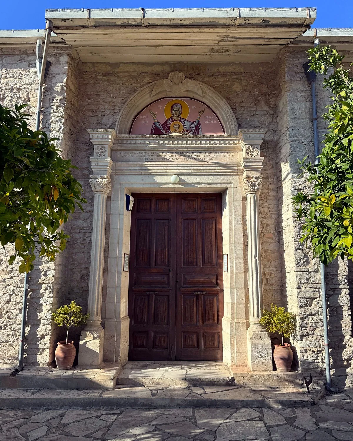 Lania village, Cyprus: we walked into every open door Carved stone doorway and icon above the wooden door of Panagia Eleousa church in Lania, Cyprus