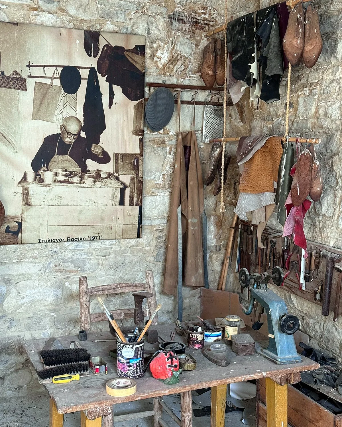 Lania village, Cyprus: we walked into every open door Old shoemaker's tools and leather on a stone wall above a workbench in Lania, Cyprus