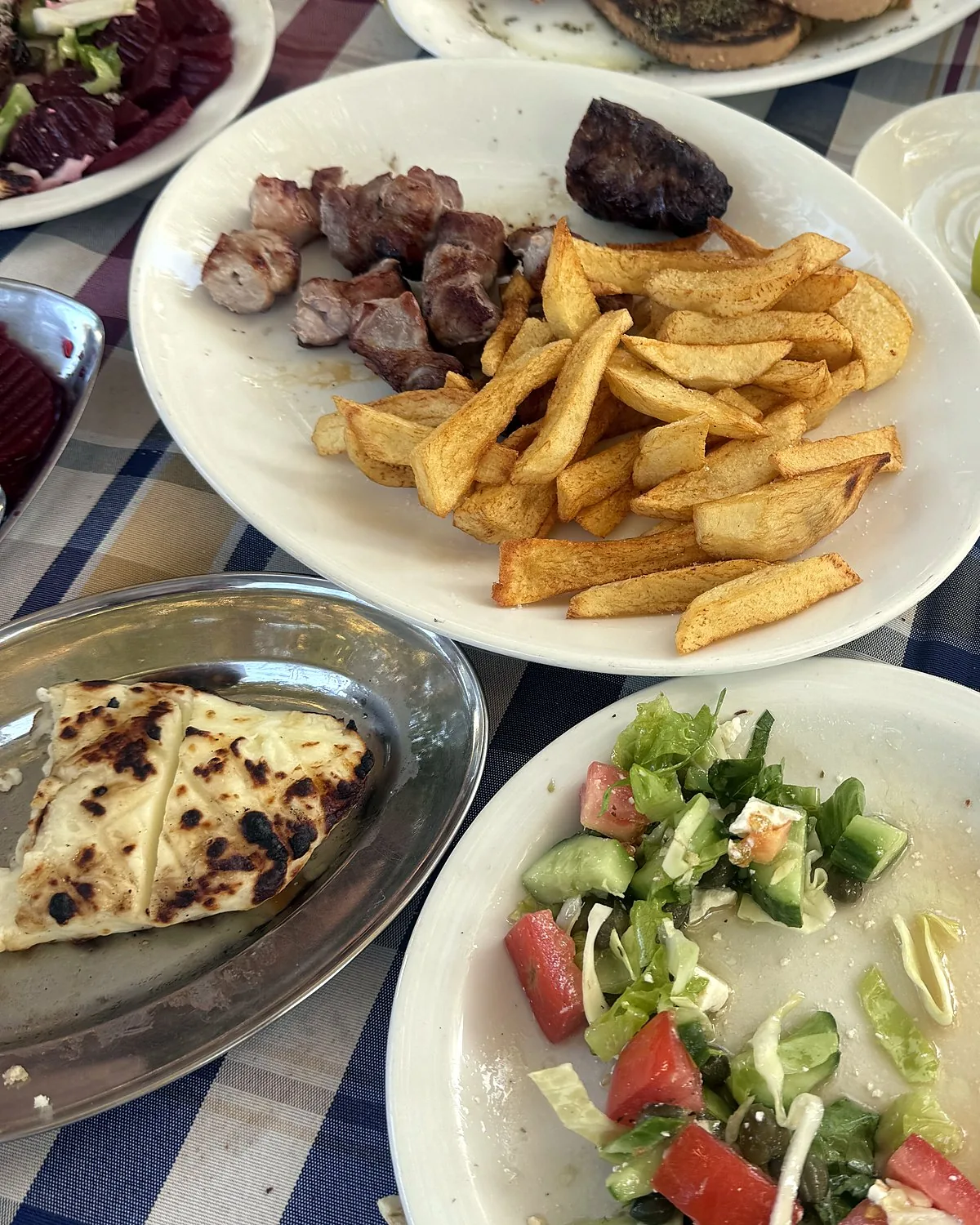 Lania village, Cyprus: we walked into every open door Pork souvlaki, chips, grilled halloumi and village salad on a checked tablecloth at Platanos Tavern, Lania