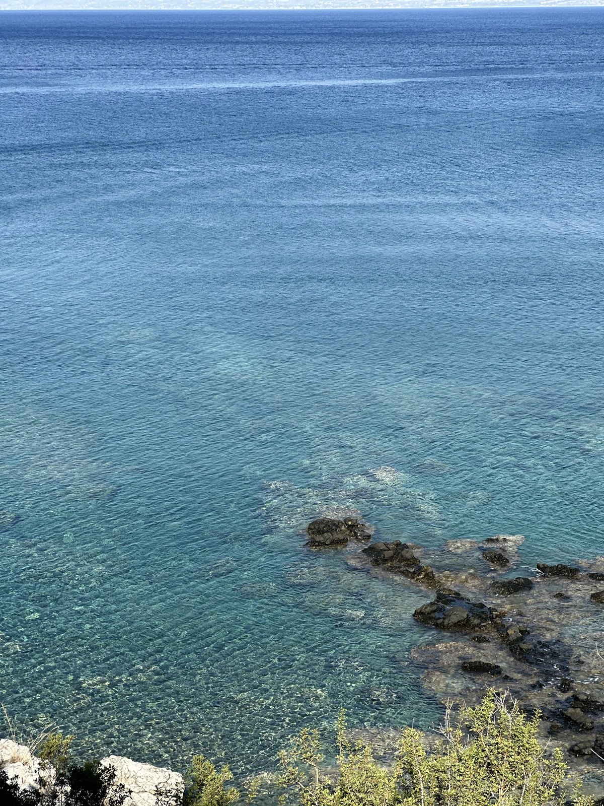 Clear turquoise water and rocks in a quiet Akamas cove
