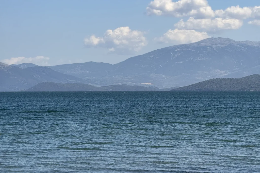The Ambracian Prawns of Preveza: The One Dish Worth the Trip Calm blue water of the Ambracian Gulf with hills in the distance