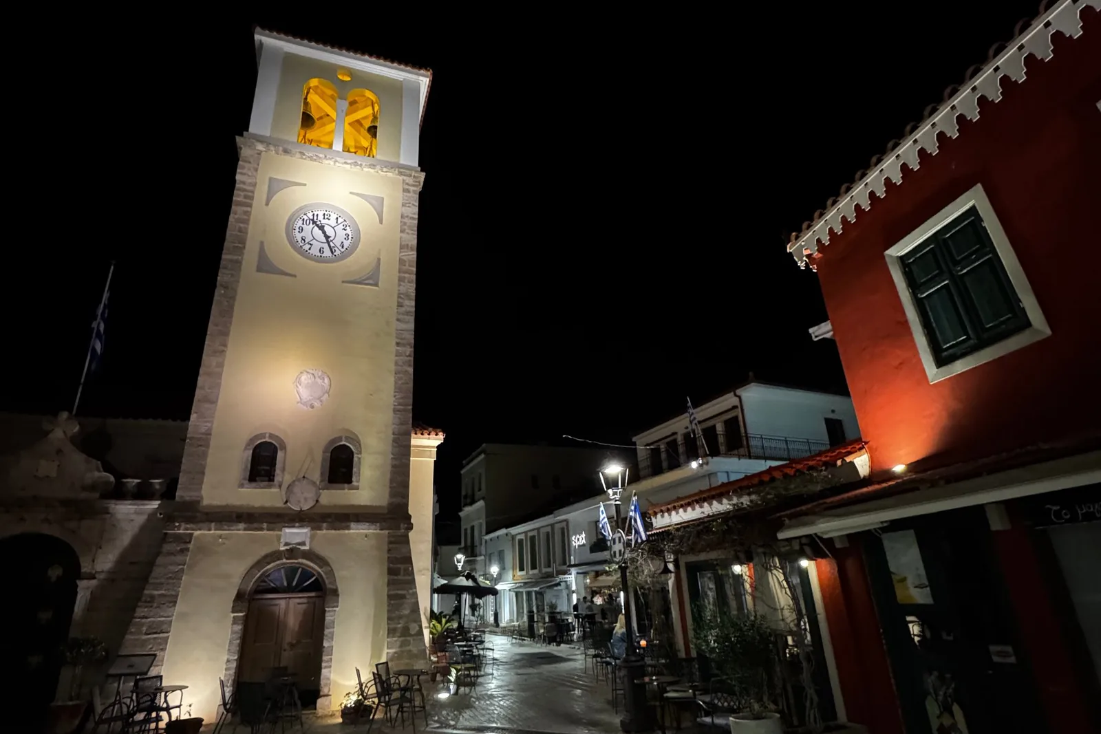 The Ambracian Prawns of Preveza: The One Dish Worth the Trip The clock tower in Preveza's old town at night, with café tables on the paved street