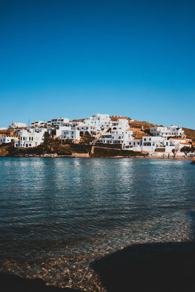 Kythnos: Where to Base Yourself and How to Get Around White houses on a hillside above a calm bay on Kythnos